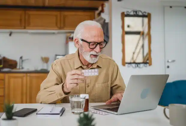 Senior man reviewing Medicare paperwork at a table
